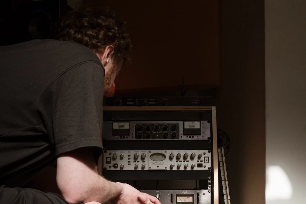 Artist at a studio console reviewing an AI music cover of an older track