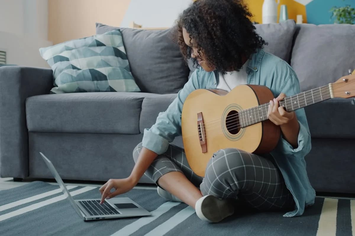 Someone writing a song on a laptop at home